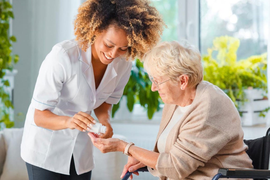 nurse assisting with pills